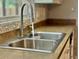 Stainless steel kitchen sink with a view from the window at 7014 Doreen St, Tampa, FL 33617