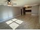 Spacious living room featuring tile flooring, neutral walls, and modern ceiling fan at 7014 Doreen St, Tampa, FL 33617