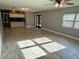 Spacious living room with tile floors, a ceiling fan, and access to kitchen area at 7014 Doreen St, Tampa, FL 33617