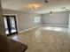 Living room with tile floor, ceiling fan, window, and access to the patio at 7014 Doreen St, Tampa, FL 33617