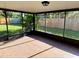 Enclosed patio with tile floor and a view of the backyard at 7014 Doreen St, Tampa, FL 33617