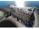 Aerial view of beach with parking lots lined with trees near the water at 764 W Bayshore Dr, Tarpon Springs, FL 34689