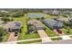Beautiful aerial view of homes with manicured lawns, and a scenic community pond at 764 W Bayshore Dr, Tarpon Springs, FL 34689