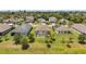 Aerial view of homes with screened pools, set among green lawns and mature trees at 764 W Bayshore Dr, Tarpon Springs, FL 34689