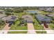 Aerial view of a residential neighborhood, showcasing the home's location near a pond at 764 W Bayshore Dr, Tarpon Springs, FL 34689