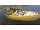 Aerial view of the beach with palm trees, parking, and clear blue water at 764 W Bayshore Dr, Tarpon Springs, FL 34689