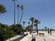 Beach with palm trees, benches, and informational signs for a relaxing day at 764 W Bayshore Dr, Tarpon Springs, FL 34689