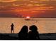 Beach at sunset with people enjoying the view, a boat in the water at 764 W Bayshore Dr, Tarpon Springs, FL 34689
