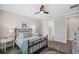 Bright bedroom with a ceiling fan, ensuite bathroom and two side tables with lamps at 764 W Bayshore Dr, Tarpon Springs, FL 34689