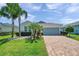 Charming home with well-manicured lawn, stone accents and brick paver driveway at 764 W Bayshore Dr, Tarpon Springs, FL 34689