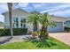 Close-up of a beautifully landscaped home exterior with stone accents and brick driveway at 764 W Bayshore Dr, Tarpon Springs, FL 34689