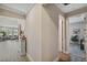 Bright hallway with stylish decor, open to the living room with lots of natural light at 764 W Bayshore Dr, Tarpon Springs, FL 34689