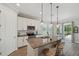 Well-appointed kitchen with granite island, modern lighting and an eat-in breakfast area at 764 W Bayshore Dr, Tarpon Springs, FL 34689