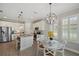 Modern kitchen features stainless appliances, a granite island, and a cozy breakfast nook with shuttered windows at 764 W Bayshore Dr, Tarpon Springs, FL 34689