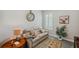 Cozy living room with comfortable seating, plantation shutters, and decorative clock at 764 W Bayshore Dr, Tarpon Springs, FL 34689