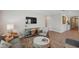 Cozy living room featuring wood floors, a modern TV, and comfortable seating, perfect for relaxing at 764 W Bayshore Dr, Tarpon Springs, FL 34689
