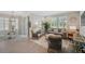 Open living area with gray sofa, wooden floors, woven chairs, and bright natural light, perfect for gathering at 764 W Bayshore Dr, Tarpon Springs, FL 34689