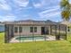 Screened-in pool offers private outdoor living with a concrete deck for relaxing at 764 W Bayshore Dr, Tarpon Springs, FL 34689