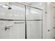 Modern shower with white tiling, a glass door, and a showerhead at 764 W Bayshore Dr, Tarpon Springs, FL 34689