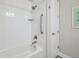 Shower and tub combination with white tile surround and installed safety bar at 764 W Bayshore Dr, Tarpon Springs, FL 34689
