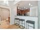 Kitchen with stainless steel refrigerator and dark wooden cabinetry, plus a view to a bathroom at 777 N Ashley Dr # 3009, Tampa, FL 33602
