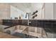 Kitchen featuring stainless steel sink with black countertop and exposed concrete pillar at 777 N Ashley Dr # 3009, Tampa, FL 33602