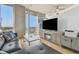 Living room featuring floor-to-ceiling windows, city views, a gray sectional, and stylish entertainment center at 777 N Ashley Dr # 3009, Tampa, FL 33602