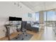 Bright living room with floor-to-ceiling windows, city views, a modern desk and stylish gray sectional at 777 N Ashley Dr # 3009, Tampa, FL 33602
