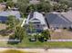 Aerial view of home featuring a screened-in pool, solar panels, and well-maintained landscaping at 8508 Canterbury Lake Blvd, Tampa, FL 33619