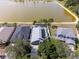 Aerial shot of a home with solar panels, fenced yard, and view of the lake and neighborhood at 8508 Canterbury Lake Blvd, Tampa, FL 33619