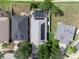 Overhead perspective showing the house with solar panels, screened-in pool, and well-kept landscaping at 8508 Canterbury Lake Blvd, Tampa, FL 33619