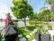A lush backyard showcases a tranquil lake view, beautiful landscaping, and a well-manicured lawn at 8508 Canterbury Lake Blvd, Tampa, FL 33619