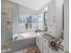Modern bathroom featuring a soaking tub, glass shower, and stylish vanity with storage at 8508 Canterbury Lake Blvd, Tampa, FL 33619