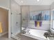 Modern bathroom featuring a glass shower, soaking tub, and stylish decor at 8508 Canterbury Lake Blvd, Tampa, FL 33619