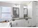 Bathroom with double sinks, decorative mirrors, and plenty of storage space at 8508 Canterbury Lake Blvd, Tampa, FL 33619
