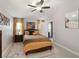 Well-lit bedroom with a cozy bed, and an adjacent door to the Primary bathroom at 8508 Canterbury Lake Blvd, Tampa, FL 33619