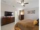 Comfortable bedroom with a ceiling fan, light colored walls, and lots of natural light at 8508 Canterbury Lake Blvd, Tampa, FL 33619