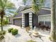 Home's beautiful entrance featuring a decorative water feature and a two-car garage at 8508 Canterbury Lake Blvd, Tampa, FL 33619