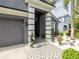 Inviting home entrance featuring a decorative tiled walkway and a two-car garage at 8508 Canterbury Lake Blvd, Tampa, FL 33619