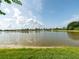 Scenic lake view featuring the serene waterfront and the surrounding landscape on a beautiful day at 8508 Canterbury Lake Blvd, Tampa, FL 33619