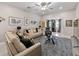 Bright living room with neutral colors, a ceiling fan, and large windows for ample natural light at 8508 Canterbury Lake Blvd, Tampa, FL 33619