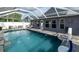 Enclosed pool area with solar panels and outdoor seating at 8508 Canterbury Lake Blvd, Tampa, FL 33619
