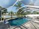 Screened-in pool area with a waterfall feature and beautiful lakeside view at 8508 Canterbury Lake Blvd, Tampa, FL 33619