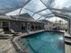 Screened pool area with solar panels and backyard seating at 8508 Canterbury Lake Blvd, Tampa, FL 33619