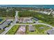 Aerial view showcasing community amenities, including a playground and tennis courts amidst lush landscaping at 8589 Saint Kitts Cir, Englewood, FL 34224