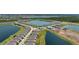 Expansive aerial view of the real estate community with long winding roads, lush vegetation, and several lakes at 8589 Saint Kitts Cir, Englewood, FL 34224