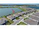 An aerial view highlighting the serene lakefront property with a fenced yard, blending privacy and scenic beauty at 8589 Saint Kitts Cir, Englewood, FL 34224
