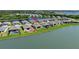 Gorgeous aerial view of the home with a lake view and featuring a screened in patio at 8589 Saint Kitts Cir, Englewood, FL 34224