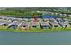 Beautiful lakefront house with a backyard fence, offering privacy and stunning water views in a planned community at 8589 Saint Kitts Cir, Englewood, FL 34224