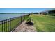 Well-maintained backyard with lush lawn and serene lake view, perfect for outdoor living at 8589 Saint Kitts Cir, Englewood, FL 34224